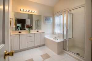 Bright and elegant contemporary bathroom featuring a bathtub, mirror, and shower with modern design elements.